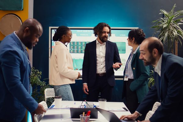 Employees addressing their team leader about practices and lessons learned, sharing issues in order to improve corporate culture within the enterprise. Discussing agenda for upcoming events. Camera B.